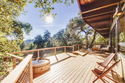 a deck with a hot tub and chairs on a house at Hot tub Disney train track in Julian amazing views in Julian