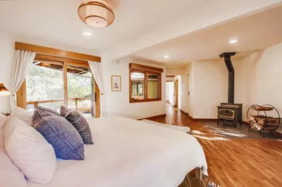 a bedroom with a white bed and a fireplace at Hot tub Disney train track in Julian amazing views in Julian