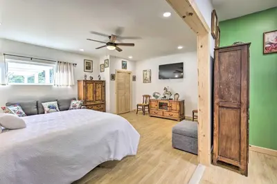 a bedroom with a white bed and a green wall at Sunny Bonita Studio about 5 Mi to Historic Dtwn! in Bonita