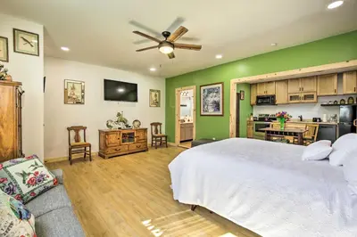a bedroom with a white bed and a green wall at Sunny Bonita Studio about 5 Mi to Historic Dtwn! in Bonita