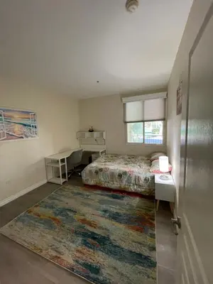 a bedroom with a bed and a rug at Resort like stay in a lovely room near UCI in Irvine