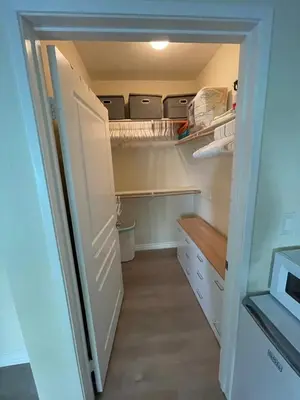 a closet with a door open to a refrigerator at Resort like stay in a lovely room near UCI in Irvine