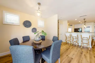 a dining room and kitchen with a table and chairs at Walk to Mission Beach Centrally Located Townhome in San Diego
