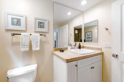 a bathroom with a toilet and a sink and a mirror at Walk to Mission Beach Centrally Located Townhome in San Diego