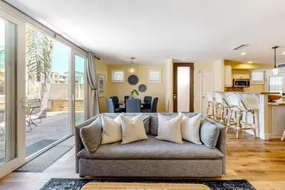 a living room with a couch and a kitchen at Walk to Mission Beach Centrally Located Townhome in San Diego