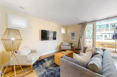 a living room with a couch and a tv at Walk to Mission Beach Centrally Located Townhome in San Diego