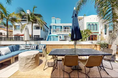 a patio with a table and chairs and an umbrella at Walk to Mission Beach Centrally Located Townhome in San Diego