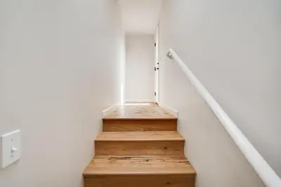 a stairwell in a house with a wooden staircase at Draper Oasis Ocean vVews in San Diego