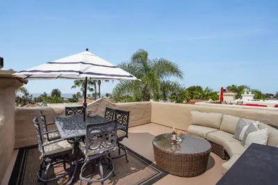 a patio with a table and chairs and an umbrella at Draper Oasis Ocean vVews in San Diego