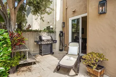a patio with a grill and a chair next to a building at Draper Oasis Ocean vVews in San Diego