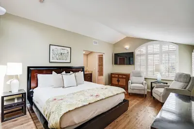 a large bedroom with a large bed and a chair at Draper Oasis Ocean vVews in San Diego
