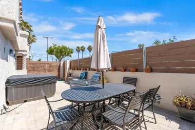 a patio with a table and chairs and an umbrella at Felspar Sanctuary in San Diego