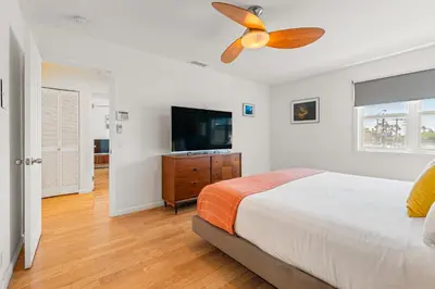 a bedroom with a bed and a ceiling fan at Felspar Sanctuary in San Diego