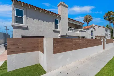 a wooden fence in front of a house at Felspar Sanctuary in San Diego