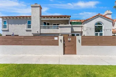 a house with a wooden fence in front of it at Felspar Sanctuary in San Diego