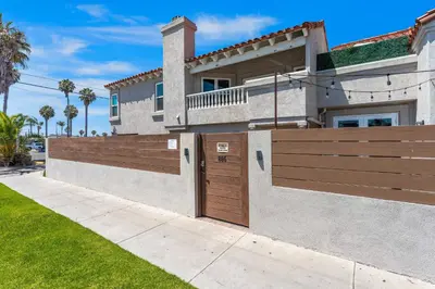 a house with a wooden gate and a fence at Felspar Sanctuary in San Diego