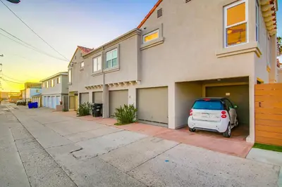 a white car parked in front of a house at Felspar Sanctuary in San Diego