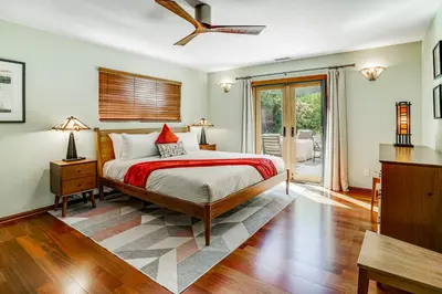 a bedroom with a bed and a sliding glass door at Hilcraft Home in Solana Beach
