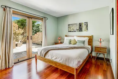 a bedroom with a bed and a sliding glass door at Hilcraft Home in Solana Beach