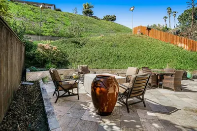 a patio with a table and chairs and a vase at Hilcraft Home in Solana Beach