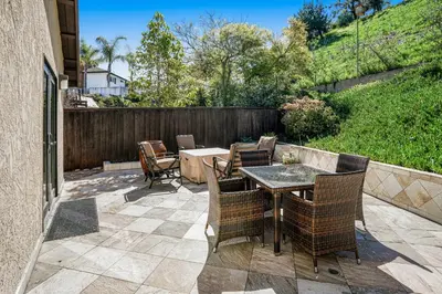 a patio with a table and chairs and a fence at Hilcraft Home in Solana Beach