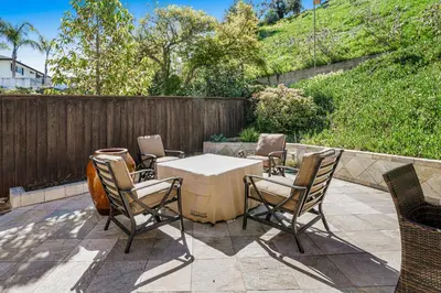 a patio with a table and chairs and a fence at Hilcraft Home in Solana Beach