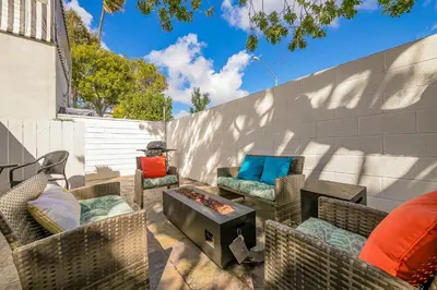 a patio with wicker chairs and a fire pit at La Jolla Beach Casita in San Diego
