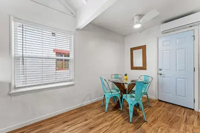 a dining room with a table and blue chairs at La Jolla Beach Casita in San Diego