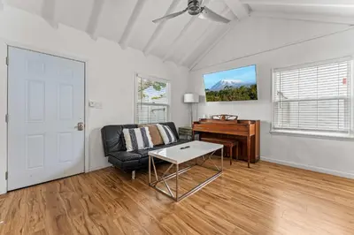 a living room with a couch and a piano at La Jolla Beach Casita in San Diego