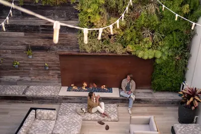 a man and woman sitting in front of a fireplace at SCP Seven4One Hotel in Laguna Beach
