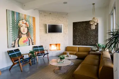 a living room with a couch and a fireplace at SCP Seven4One Hotel in Laguna Beach