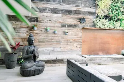 a statue sitting in front of a wall at SCP Seven4One Hotel in Laguna Beach