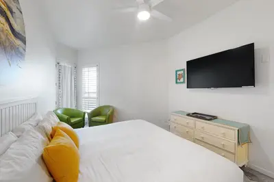 a bedroom with a bed and a television on the wall at Santa Barbara Unit #2 in San Diego