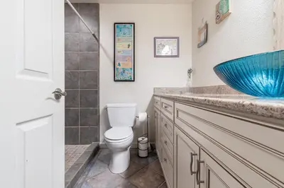 a bathroom with a toilet and a blue sink at Santa Barbara Unit #2 in San Diego