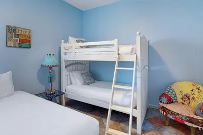 a bedroom with a bunk bed and a ladder at Santa Barbara Unit #2 in San Diego