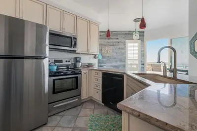 a kitchen with a stainless steel refrigerator and a sink at Santa Barbara Unit #2 in San Diego