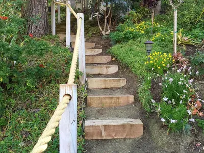 a set of stairs with a rope and flowers at Coastal Hideaway in Carlsbad