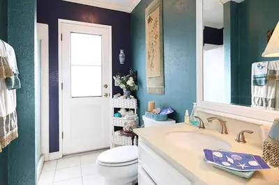 a bathroom with a white sink and a toilet at Coastal Hideaway in Carlsbad