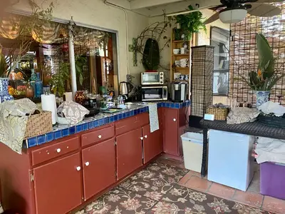 a kitchen with red cabinets and a microwave at Coastal Hideaway in Carlsbad