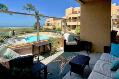 a patio with a view of a swimming pool at Ocean Pointe Lagoon 107 - 30 Night Minimum in Carlsbad