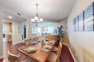 a dining room with a wooden table and chairs at Ocean Pointe Lagoon 107 - 30 Night Minimum in Carlsbad