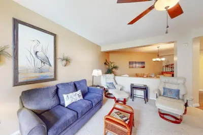 a living room with a blue couch and chairs at Ocean Pointe Lagoon 107 - 30 Night Minimum in Carlsbad