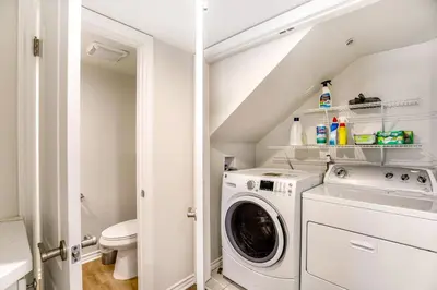 a white laundry room with a washer and dryer at Carlsbad Village Charm in Carlsbad