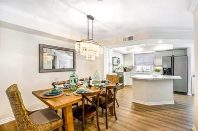 a dining room and kitchen with a table and chairs at Carlsbad Village Charm in Carlsbad
