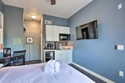 a room with a bed and a small kitchen at Torrey Spa Suite Modern San Diego Studio! in San Diego