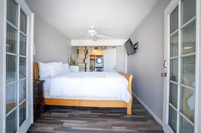 a bedroom with a bed and a ceiling fan at BEACHFRONT COTTAGE LOWER UNIT in Oceanside