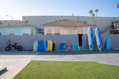 a row of surfboards lined up against a fence at BEACHFRONT COTTAGE LOWER UNIT in Oceanside