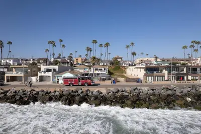a fire truck is parked next to the water at BEACHFRONT COTTAGE LOWER UNIT in Oceanside