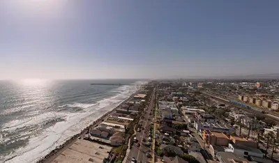 an aerial view of a beach and the ocean at BEACHFRONT COTTAGE UPPER UNIT in Oceanside