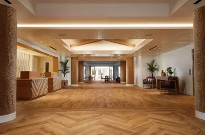 an office lobby with wooden floors and a large hall at Shore House at The Del, LXR Hotels & Resorts in San Diego